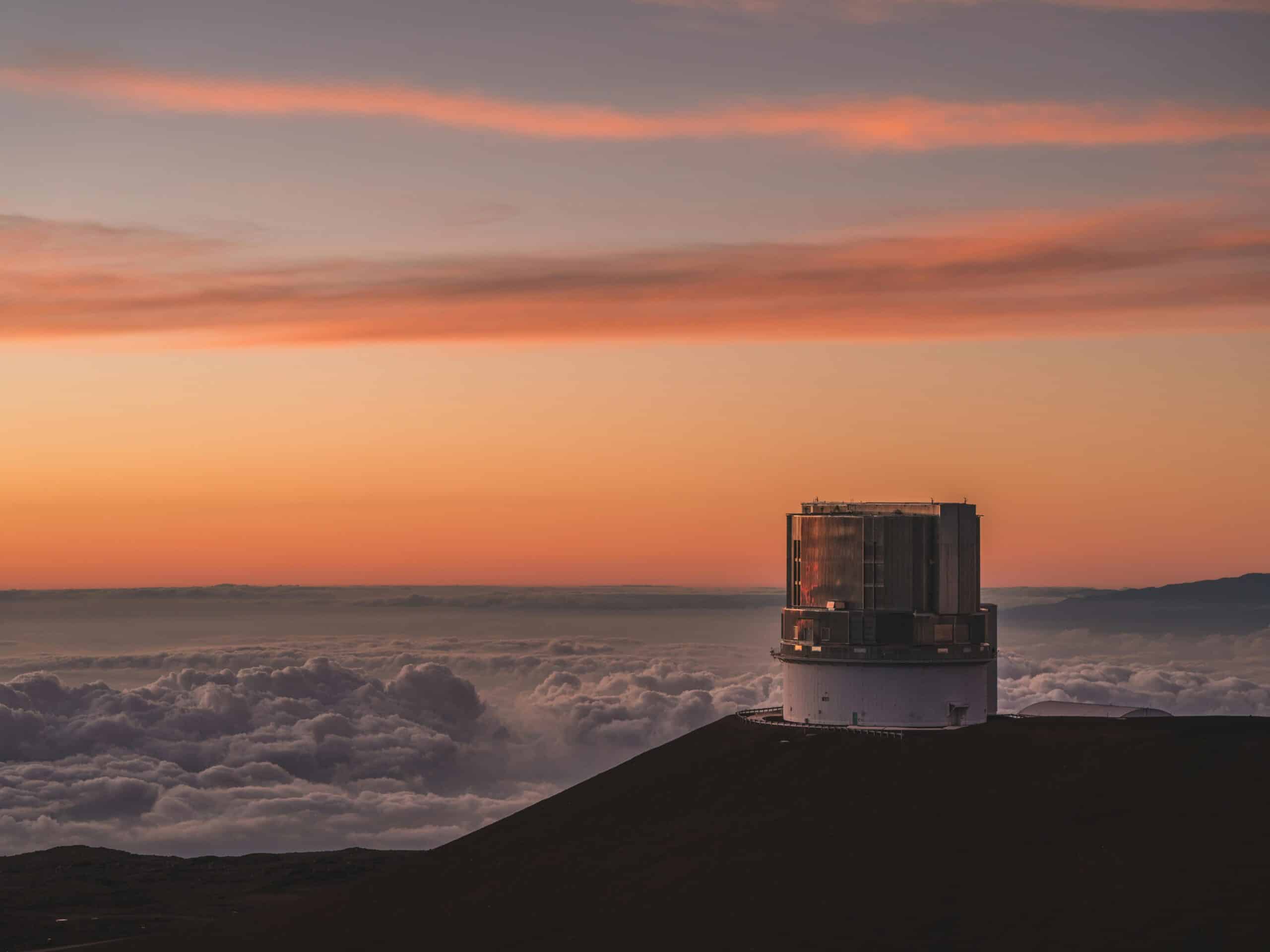 Innovative observatory atop a mountain during sunset, symbolising scientific research and environmental monitoring.
